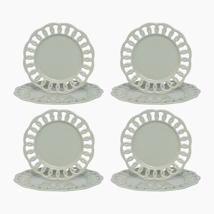 Sage green ceramic dinner and salad plates stacked to show layered lace borders