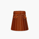 Handcrafted rattan cordless lamp in burnt orange, artisan home decor with elegant velvet finish and decorative bow.