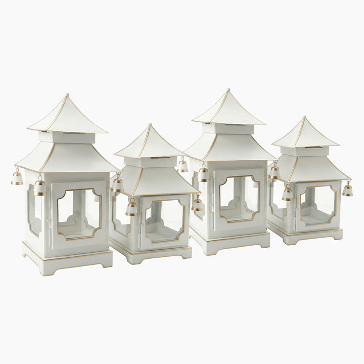 Four ivory pagoda candle lanterns in two heights with gold accents and hanging bells