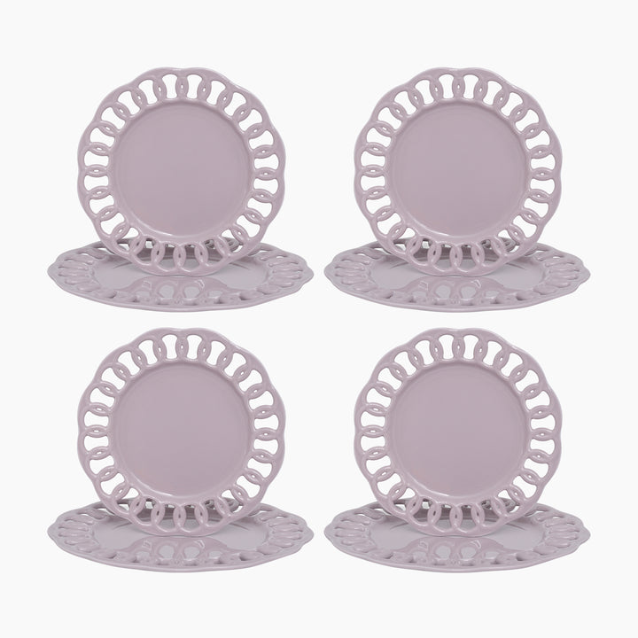 Pink violet ceramic dinner and salad plates stacked to show layered lace borders