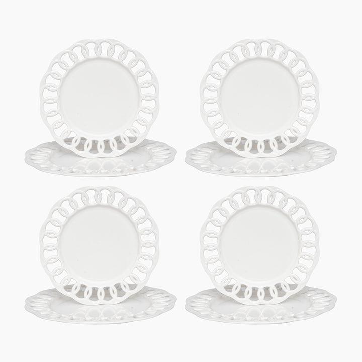 White ceramic dinner and salad plates stacked to show layered lace borders