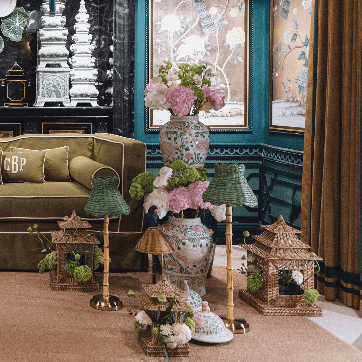 Elegant living room featuring a bamboo rechargeable lamp with seagrass shade, colorful vases, and decorative accents.
