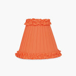 Handcrafted rattan cordless lamp with an orange ruffled lampshade for vibrant home decor.