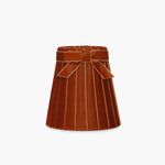 Handcrafted rattan cordless lamp in burnt orange, artisan home decor with elegant velvet finish and decorative bow.