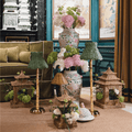 Stylish living space featuring bamboo rechargeable lamp with seagrass shade and decorative vases, enhancing artisan home decor.